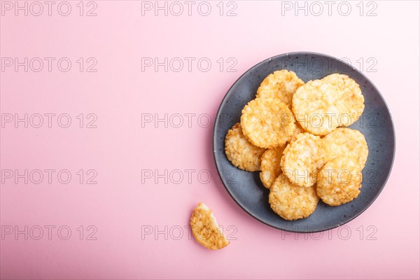 Traditional japanese rice chips cookies with honey and soy sauce on a pastel pink background. Top