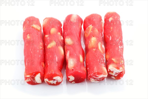Red traditional turkish delight (rahat lokum) with peanuts isolated on white background. side view,