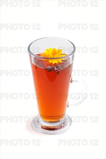 Glass of herbal tea with calendula and hyssop isolated on white background. Morninig, spring,