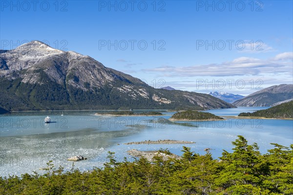 Cruise ship Stella Australis anchored between ice floes in Pia Bay in front of the Pia Glacier,
