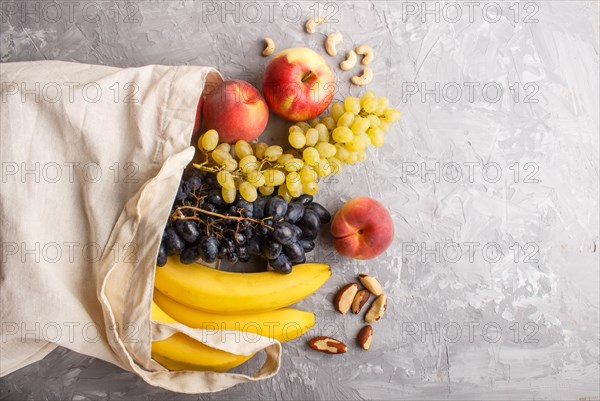 Fruits in reusable cotton textile white bag. Zero waste shopping, storage and recycling concept,