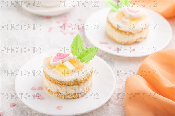 Decorated cake with milk and coconut cream with cup of coffee on a gray concrete background and