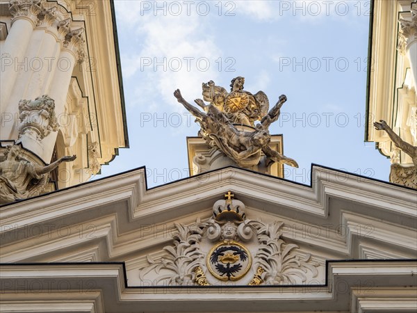 Sculpture, depiction of a saint on the gable of the church, Archangel Michael pushing Lucifer into