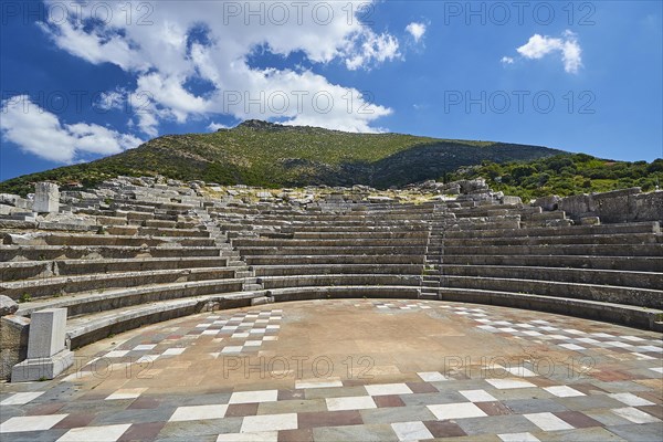 Sunny view of the ancient theatre with a view of the stage and the rows of seats, Asklepios