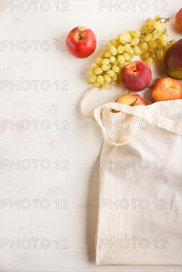 Fruits in reusable cotton textile white bag. Zero waste shopping, storage and recycling concept,