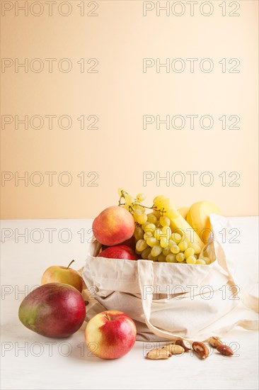 Fruits in reusable cotton textile white bag. Zero waste shopping, storage and recycling concept,