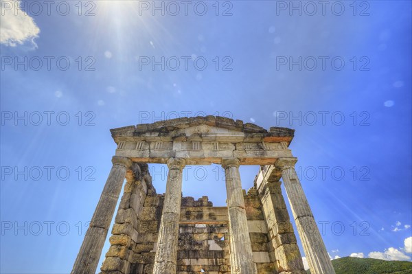 Sky-blue background behind the imposing remains of an ancient temple, Mausoleum, Heroon,