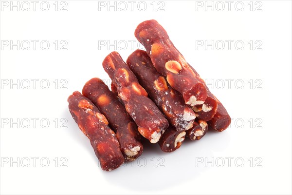 Brown traditional turkish delight (rahat lokum) with peanuts isolated on white background. side