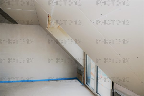 Attic conversion, loft conversion. You can see the pitched roof with door and skylight panelled