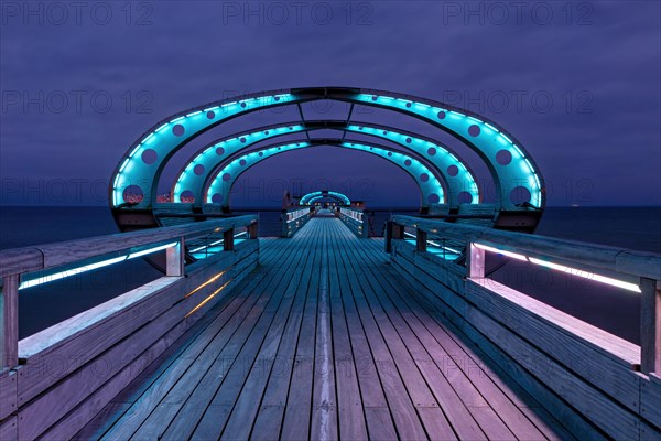 Long exposure during the blue hour of the pier of Kellenhusen at the Baltic Sea with blue