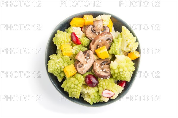 Vegetarian salad from romanesco cabbage, champignons, cranberry, avocado and pumpkin in black bowl