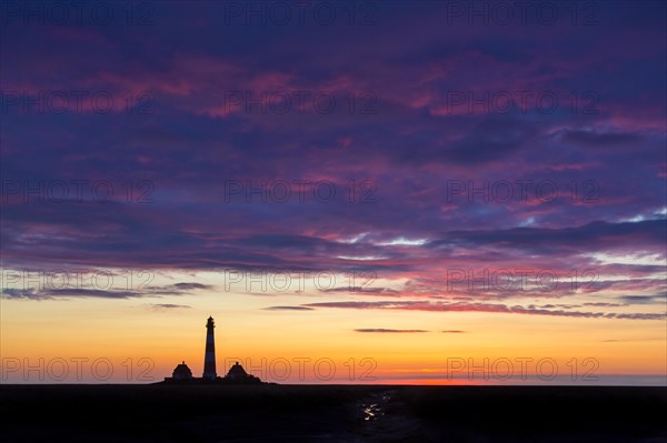 Lighthouse Westerheversand silhouetted against blue sunset sky, Westerhever, Wadden Sea National