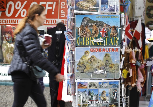 A shop in Gibraltar offers postcards with Gibraltar motifs.thousands of Spaniards commute from