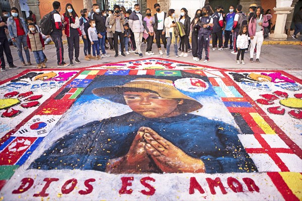 Peruvian people look at a floor painting in the Plaza de Armas, Ayacucho, Huamanga province, Peru,