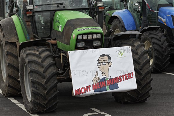 Sign with drawn Minister of Agriculture Cem Oezdemir on a tractor, farmer protests, demonstration