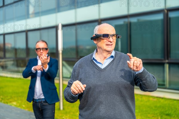Businessman experiencing with augmented mixed vision headset in an urban park next to financial