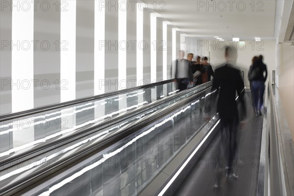 Members of the German Bundestag run across a treadmill between the Reichstag and Paul Loebe Haus,