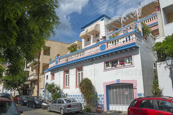 Colourful house with blue tiles and decorations on a busy street in the old town, Kavala, Dimos