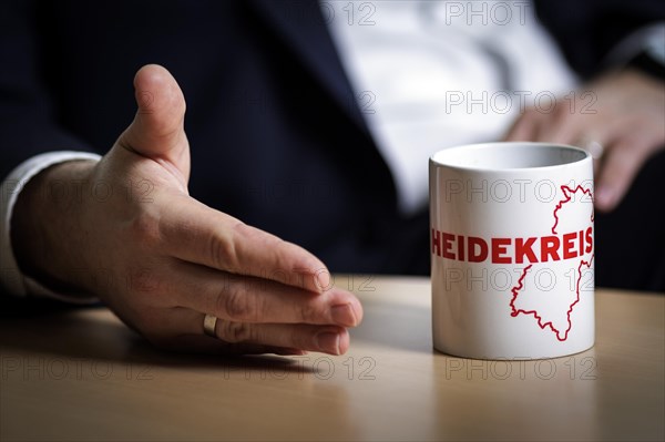 Lars Klingbeil, SPD party leader, gestures next to a cup labelled Heidekreis during an interview in