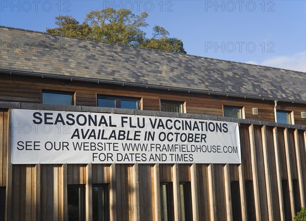 Seasonal flu vaccinations available poster sign on Framfield health centre, Woodbridge, Suffolk,