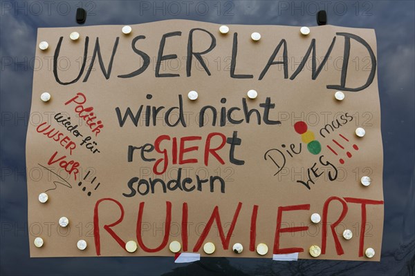 Sign criticising the government on a car, farmers' protests, demonstration against policies of the