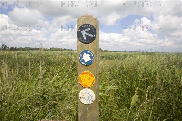 Route markers for Angles Way long distance footpath in marshes near Oulton Broad, Suffolk, England,