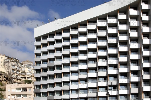 A high-rise hotel stands next to two small old hotels on the beach in Torremolinos, Spain, Costa