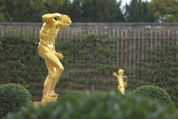 Satyr with cymbal as golden statue, sculpture, golden, cymbal player, shining, shining, orangery,