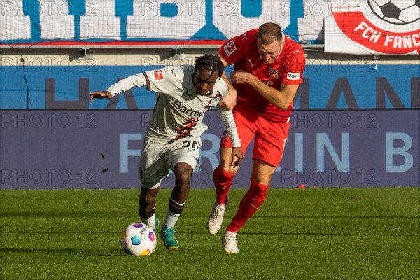 Football match, Jeremine FRIMPONG Bayer Leverkusen left in duel with Jonas FOeHRENBACH 1.FC