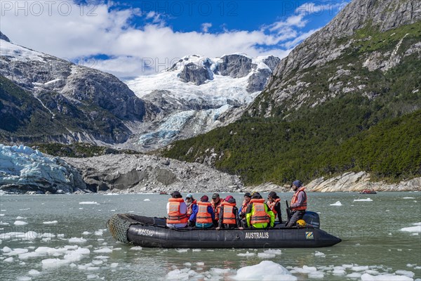 Passengers of the cruise ship Stella Australis in rubber dinghies in front of the ice of the Porter
