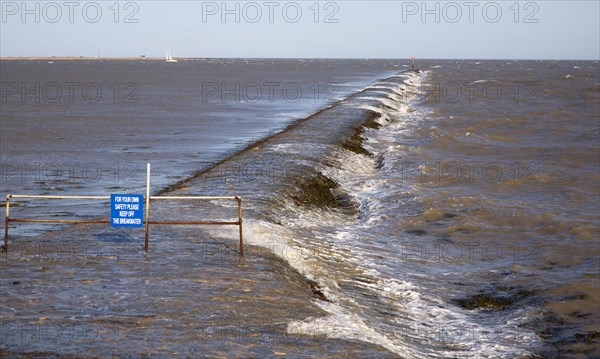 High seas forcing waves over the harbour mouth breakwater at Harwich, Essex, England, United