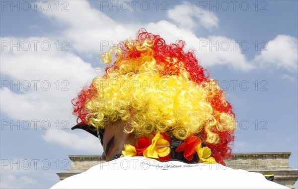 Football fan wears a wig with the colours of the German flag for the World Cup opening match