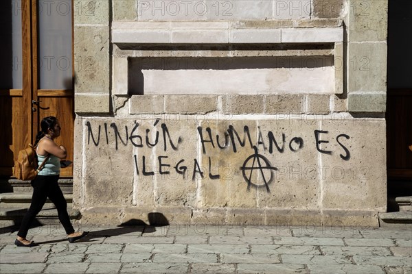 Oaxaca, Mexico, Graffiti on a wall reads No Human is Illegal. Many migrants are making their way