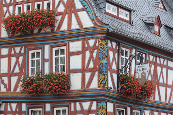 Half-timbered house and Gasthof zur Pfeif with ornaments, floral decoration and nose sign,