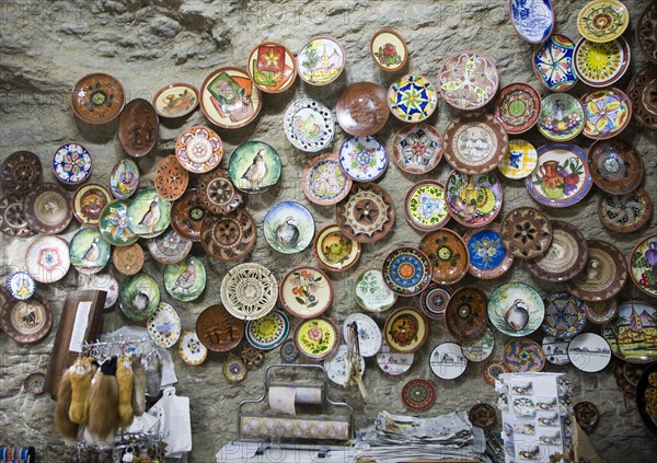 Ceramic plates on display on wall of cave shop Setenil de las Bodegas, Cadiz province, Spain,