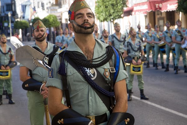 Military band parade of soldiers marching for National day celebrations in Ronda, Spain, Europe