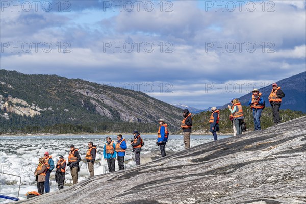 Passengers of the cruise ship Stella Australis waiting in line for a rubber dinghy at Pia Glacier,