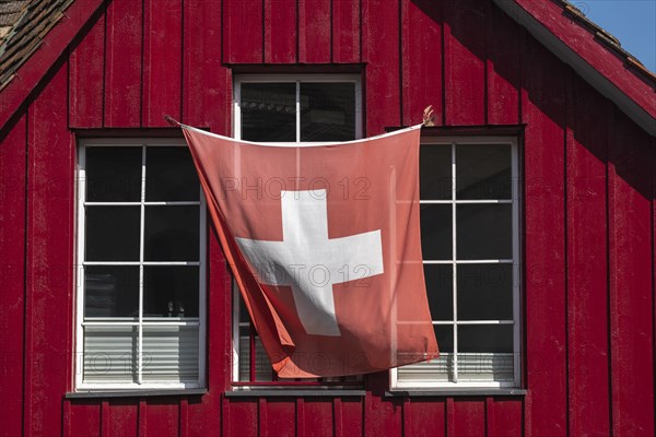 Stein am Rhein, old town, wooden house, colour red, swiss flag, wind, canton Schaffhausen,