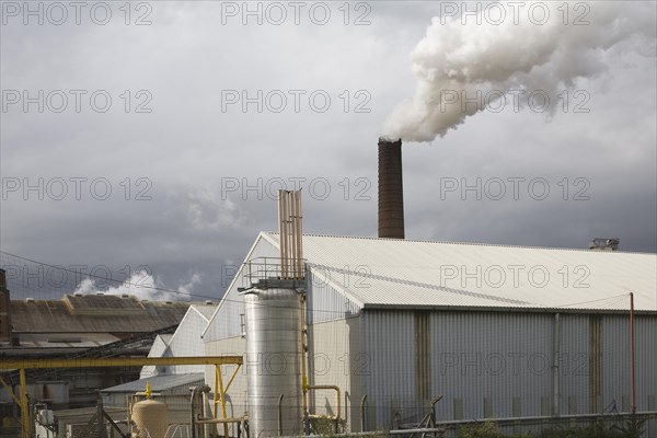 Steam rising from chimneys as sugar beet is processed at the British Sugar factory, Bury St