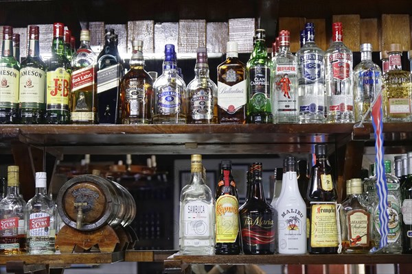 Rum bottles, liqueur bottles, restaurant near Santa Clara, Cuba, Greater Antilles, Caribbean,