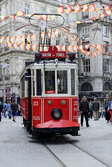 Historic tram Nostaljik Tramvay travelling through Istiklal Caddesi shopping street, Beyoglu,