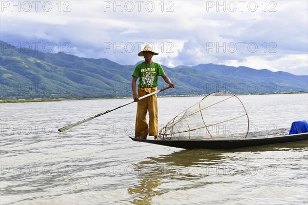 Intha fisherman, local man fishing with traditional conical fishing net, Inle Lake, Burma, Myanmar,