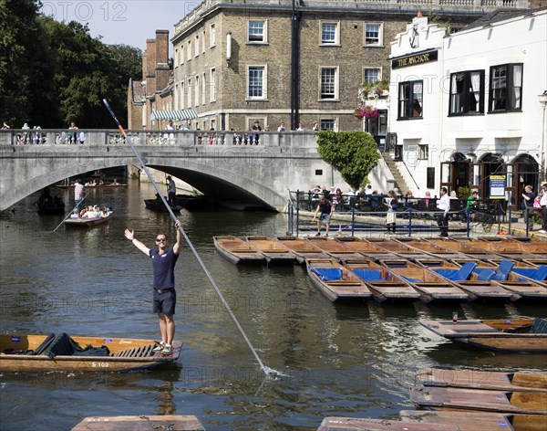 People punting in small boats on the River Cam near Silver Street Bridge, Cambridge, England,