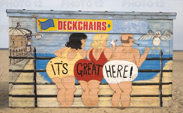 Painted deckchair hire shed with traditional seaside picture of people in swimming costumes, Great