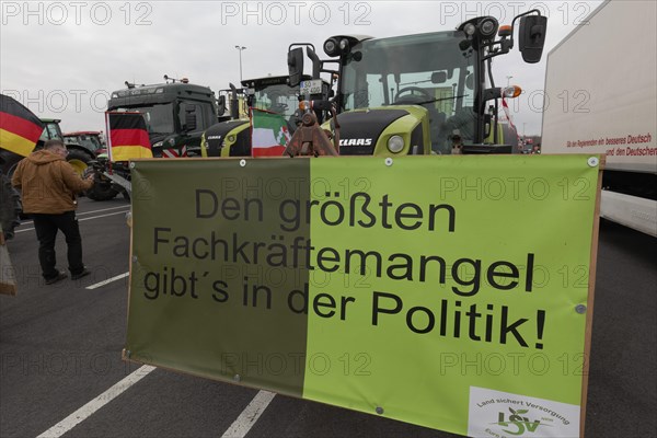 Sign on the subject of shortage of skilled labour on a tractor, farmers' protests, demonstration