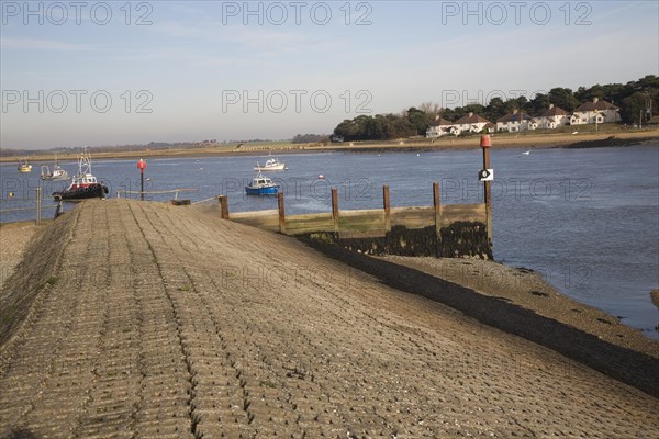 Concrete inclined sea wall embankment River Deben, Felixstowe Ferry, Suffolk, England, United