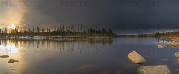 View over the Harz Oderteich in winter, dam, sunset, panorama, landscape format, evening light,