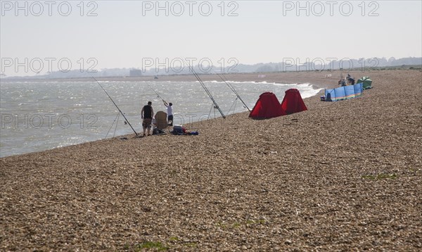 People sea fishing from beach, Hollesley Bay, Shingle Street, Suffolk, England, United Kingdom,