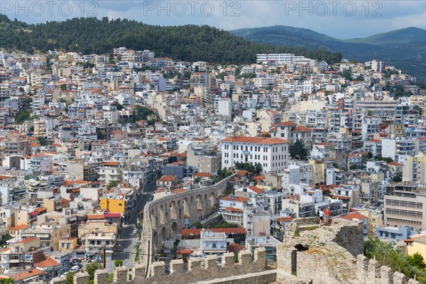 Roman aqueduct, dense development of a town situated on the slopes of a hill, view from the