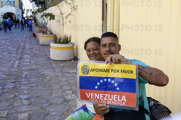 Oaxaca, Mexico, A man and a woman trying to make their way from Venezuela to the United States hold
